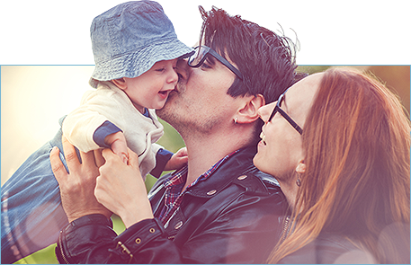 Photo of Smiling, Happy couple with baby wearing quality eyewear